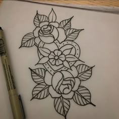 a drawing of a rose with leaves on paper next to a marker and some pens