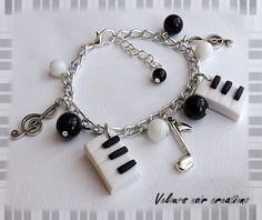 a white and black charm bracelet with musical instruments