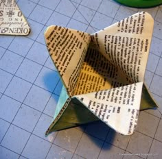 an origami paper boat sitting on top of a table