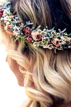 a woman with long blonde hair wearing a flower crown