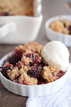 a bowl filled with fruit and ice cream on top of a wooden table next to another bowl