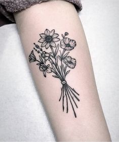 a black and white photo of flowers on the arm