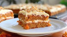 a piece of carrot cake on a plate with the rest of the cake in the background