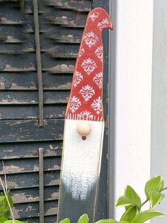 a skateboard with a red and white design on it sitting in front of a door