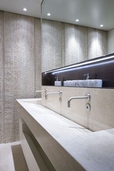 a bathroom with two sinks and mirrors in the wall next to each other on top of a counter