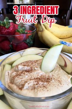 an apple and cinnamon dip in a bowl with strawberries on the table behind it