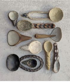 an assortment of spoons sitting on top of a white counter next to each other