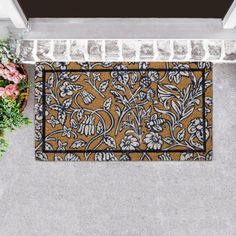 an overhead view of a door mat with flowers on the front and side of it