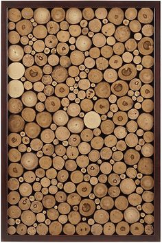 wood logs stacked up in a wooden frame with circles and holes on the top, as if they were cut into smaller pieces