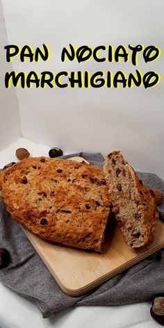 a loaf of bread sitting on top of a cutting board next to some chocolate chips