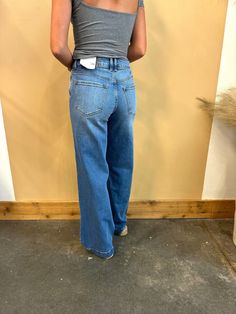 Introducing our Bertha High Rise Trouser Wide Leg Jeans, the perfect way to express your unique style! With a flattering high rise and relaxed leg, these jeans feature a medium wash with light fading and whiskering for a trendy look. Equipped with 2 deep front pockets, light distress detail, button closure, and zip fly. Made from 99% cotton and 1% spandex for ultimate comfort. 11" Rise / 32" Inseam Size (5/26) 99% Cotton, 1% Spandex Stretchiness >> Comfort Stretch Runs long SIZE WAIST HIP 24 26" Business Casual Flats, Bridal Business, High Rise Wide Leg Jeans, Romper Outfit, Going Out Tops, Casual Flats, Sneakers For Sale, Wide Leg Jeans, Business Casual