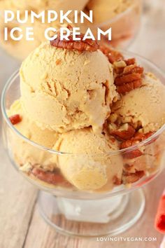 three scoops of ice cream with pecans in the middle on a wooden table