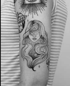 a woman's arm with an all seeing eye tattoo on the left upper arm