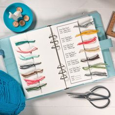 an open book with crochet hooks and yarn