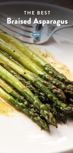 asparagus on a white plate with mustard sauce