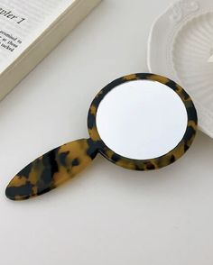 a magnifying glass sitting on top of a table next to an open book