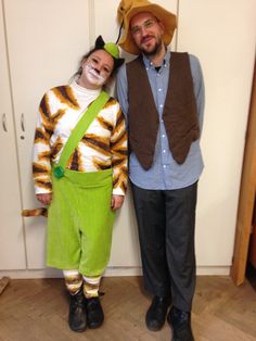 two people standing next to each other wearing costumes