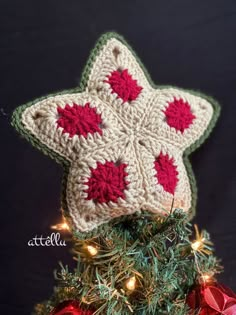 a crocheted star ornament on top of a christmas tree