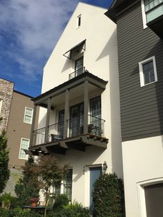 an apartment building with balconies on the second floor