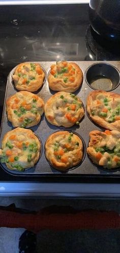 there are many small pies in the pan on the stove top, ready to be cooked