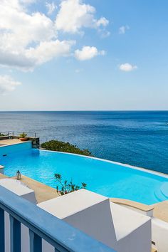 an empty swimming pool overlooking the ocean