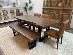 a dining room table with benches and chairs