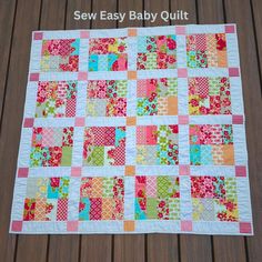 an easy baby quilt is shown on the ground with text overlay that says sew easy baby quilt