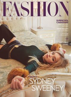 a woman laying on top of a bed next to a teddy bear