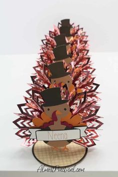 an origami christmas tree made out of folded paper with the name nena on it