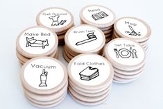 a pile of wooden buttons with different types of items on them and words written in black ink