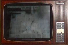 an old television set sitting on top of a table