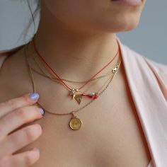 Introducing our Evil Eye Tassel Necklace, a top-seller from Sunday Forever. This must-have piece features an evil eye and small red tassel, available in either sterling silver or 14k gold filled. Wear it alone for a delicate touch or pair it with other necklaces for a layered look. It also makes for a thoughtful gift, packaged in our signature snap case and drawstring Nice Things pouch, complete with a description card. Plus, the chain can be easily adjusted from 15" to 17.5" for the perfect fit Good Luck Charm Necklace With Delicate Chain, Red Necklace With Star Charm As Gift, Red Necklace With Star Charm For Gift, Gift Lariat Charm Necklaces, Charm Necklace Diy, Gold Tassel Necklace, Cotton Pouch, Beads Bracelet Design, Dope Jewelry