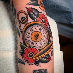 an arm with a clock and flowers on it