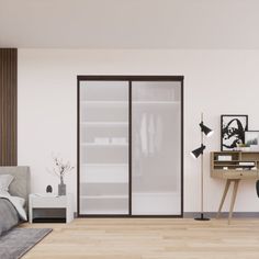 a bedroom with a bed, desk and sliding glass closet doors in the middle of it