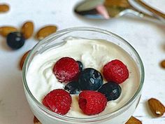 yogurt with berries and almonds in a glass bowl