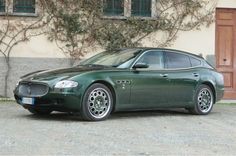 a green car parked in front of a building