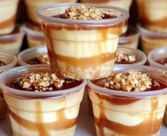 desserts are arranged in plastic cups with toppings on the top and bottom, ready to be eaten