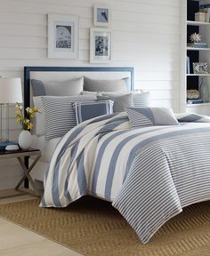 a bed with blue and white striped comforter