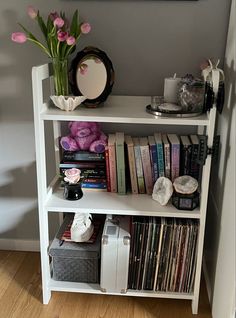 a white book shelf filled with lots of books