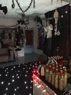 a room decorated for halloween with candles and decorations