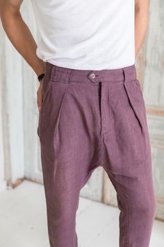 "Linen drop-crotch pants for men are a part of your casual outfit or any specific occasion. A loose cut around the thigh with a narrow shape through the leg feels very comfortable even during the hottest days. The above ankle length of the pants looks good with sandals as well as sneakers. These stylish pleated pants have four pockets - one at each side and two in the back. You will be beloved to wear them! DETAILS: - OEKO-TEX certified product (Sustainable Textile) - Zip fly with two buttons cl Casual Bottoms With Belt Loops For Festivals, Bohemian Linen Bottoms With Pockets, Bohemian Tapered Leg Bottoms With Pockets, Bohemian Bottoms With Tapered Leg And Pockets, Bohemian Bottoms With Pockets And Tapered Legs, Baggy Linen Bohemian Pants, Bohemian Bottoms With Relaxed Fit And Tapered Leg, Bohemian Summer Pants With Tapered Leg, Bohemian Tapered Leg Summer Pants