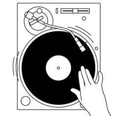 a hand holding a record player in front of a turntable