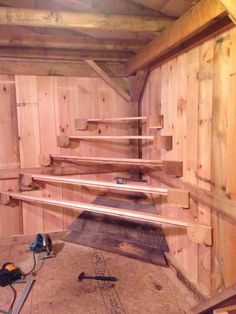 the inside of an unfinished building with wood planks on the walls and flooring