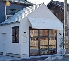 a small white building sitting on the side of a road