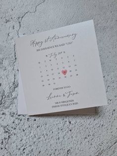 a calendar on top of a piece of paper with the word happy anniversary written in it