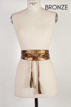 Stylish Obi leather belt handmade in our atelier with high-quality soft metallic leather in bronze color. Perfect to empower your look when you have to go to a wedding or special event. This glamorous obi belt has two small tassels at the end of the ties. It combines with blouses, pants, tunics, skirts, jeans, long baggy shirts, and all kinds of dresses.  Available in three sizes and also in other metallic leather colors. See color options. ##MEASURES: Width in all sizes (Widest part): 3 inches/ Leather Party Belts, Chic Brown Party Belt, Chic Brown Belt For Party, Brown Leather Belts For Party, Brown Leather Belt For Party, Brown Leather Party Belts, Chic Leather Corset Belt For Party, Luxury Gold Belt With Self Belt, Luxury Corset Belt For Party