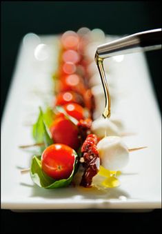 a long row of skewers filled with different types of vegetables and sauces