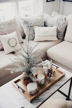 a living room filled with lots of furniture and decor on top of a wooden tray