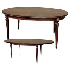 an oval table with two smaller tables underneath it