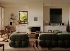 a living room filled with furniture and a fire place in the middle of a room